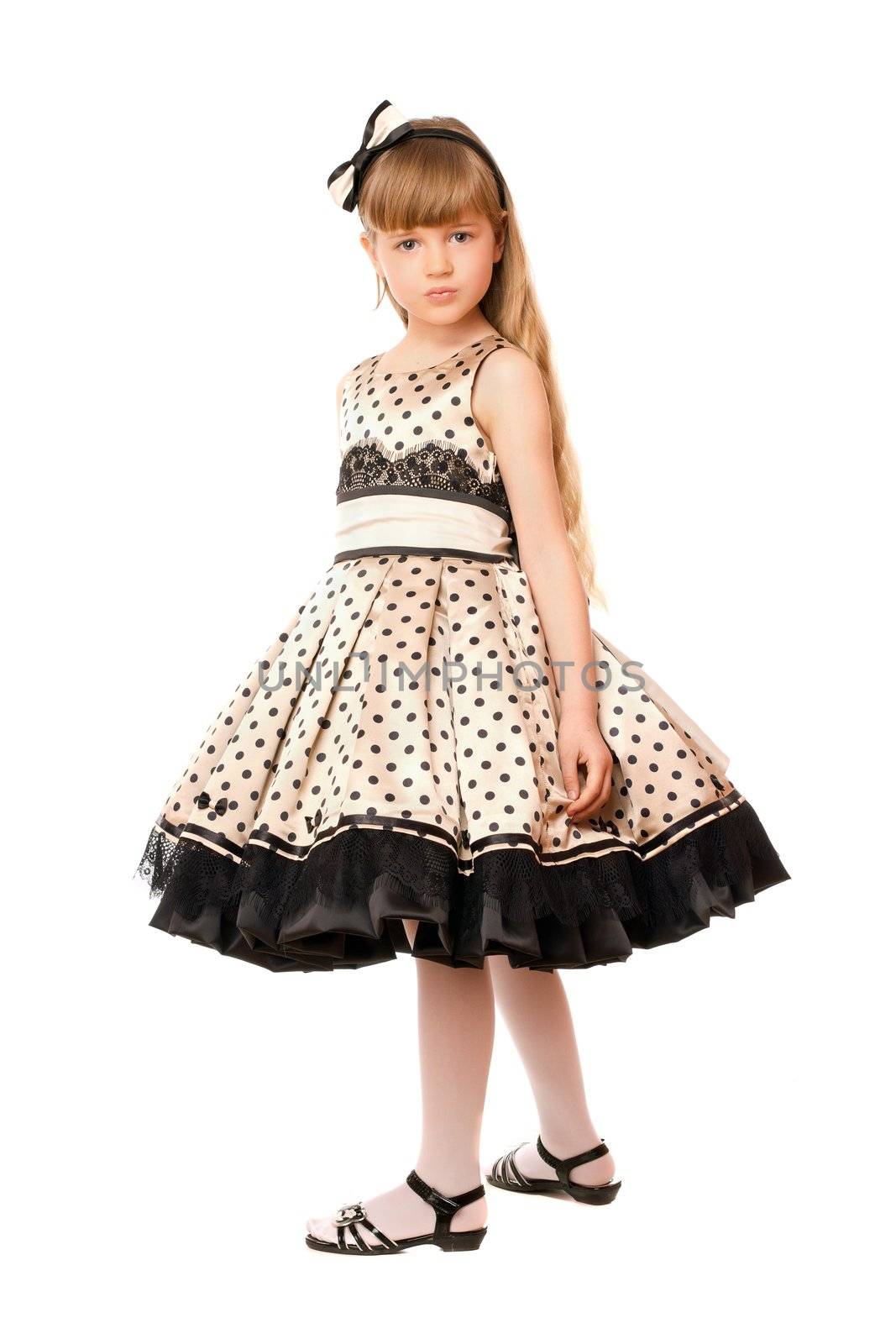 Charming little girl in a dress. Isolated