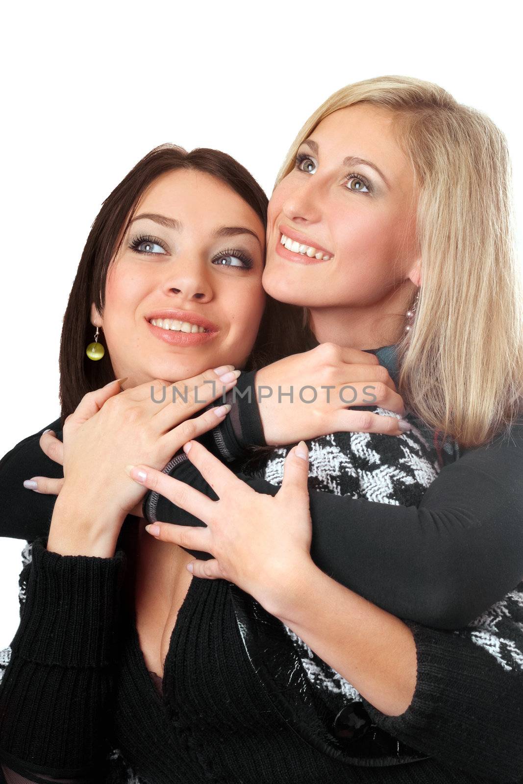Portrait of two attractive young women embracing. Isolated