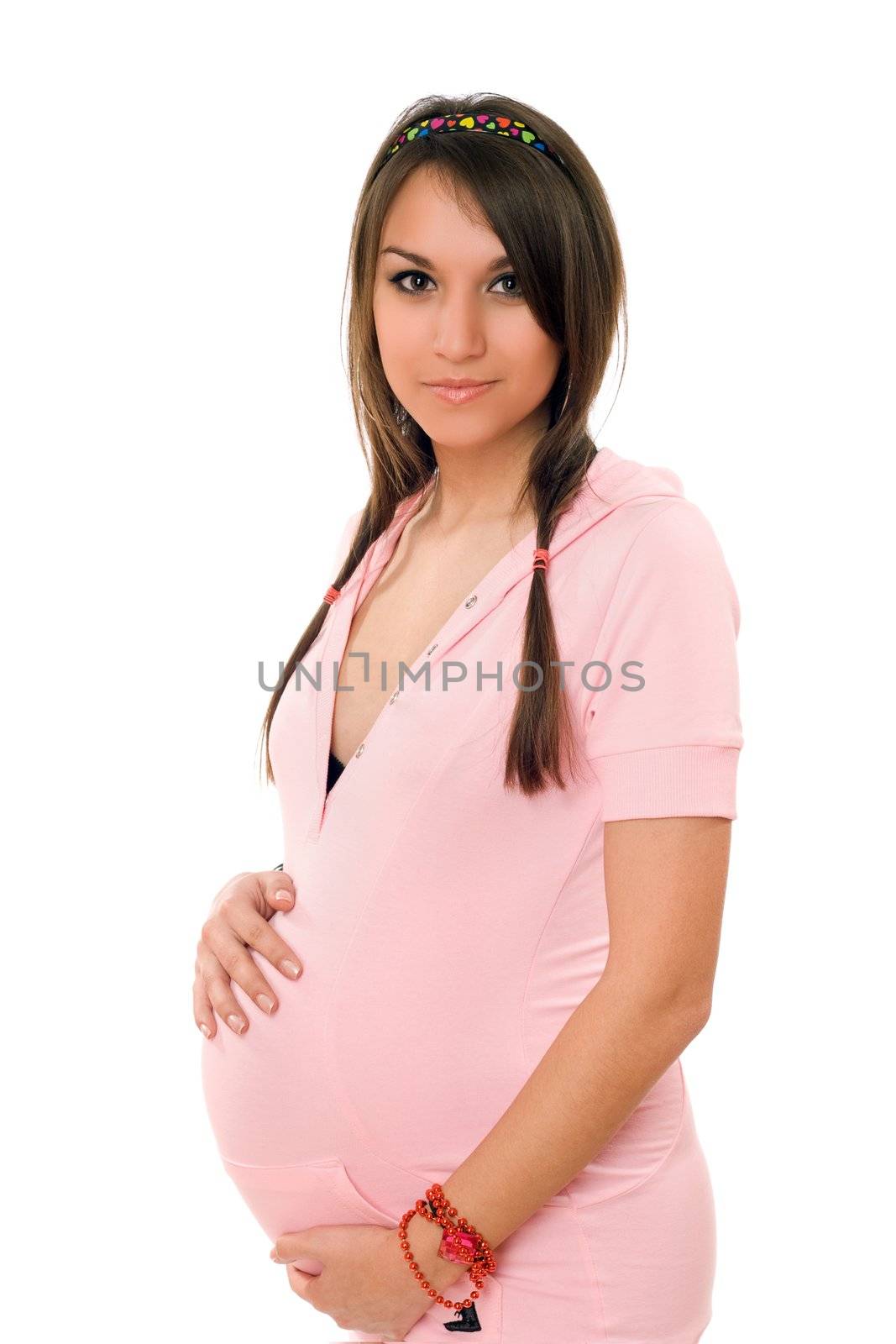Beautiful young pregnant brunette woman. Isolated
