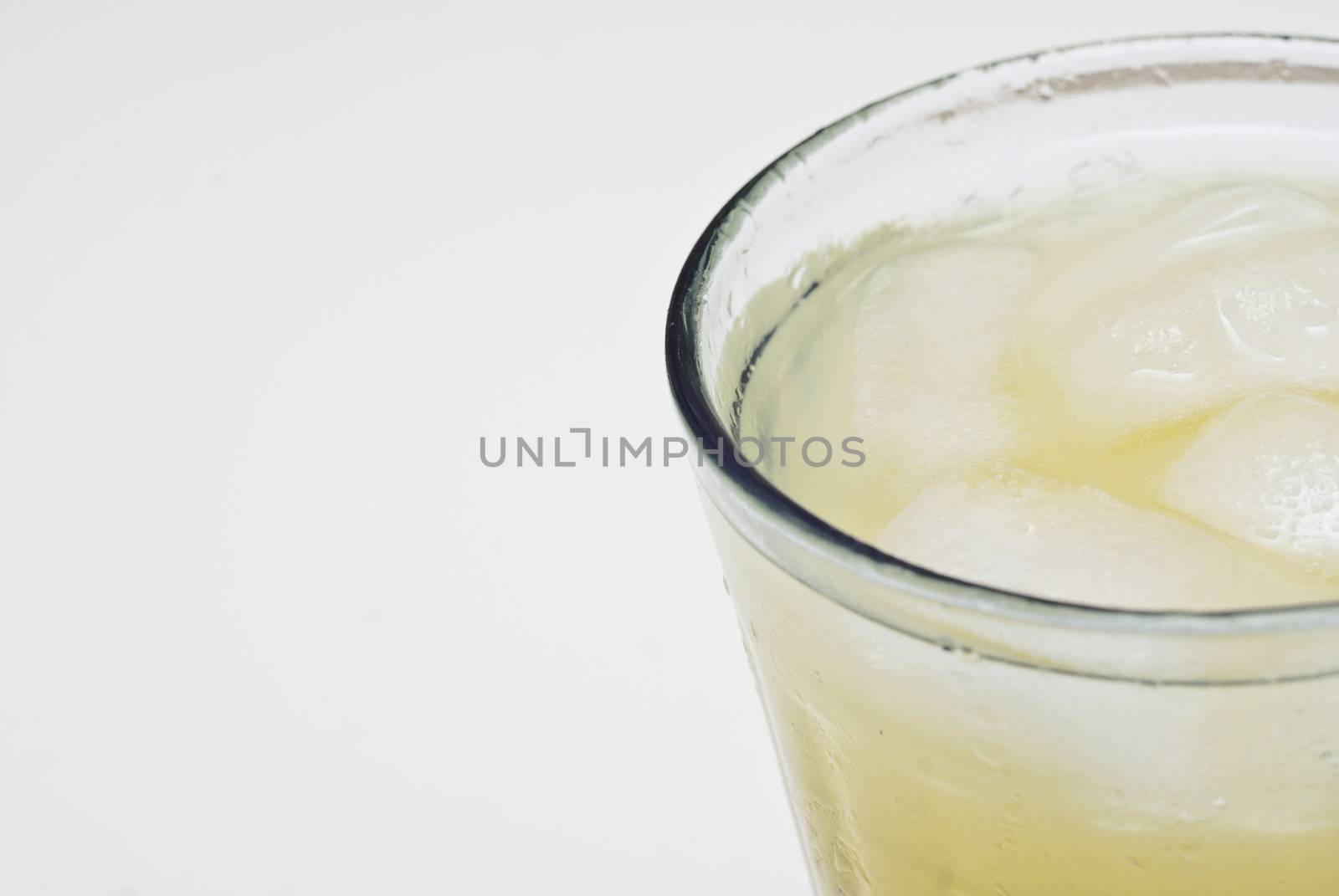 macro of a cocktail glass with ice isolated on white background