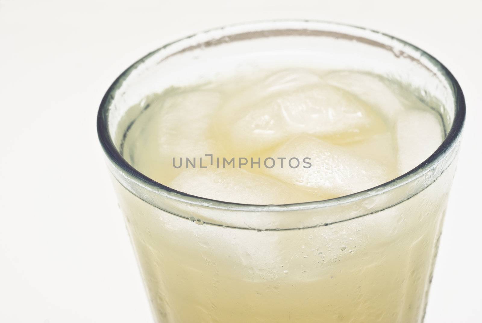 macro of a cocktail glass with ice isolated on white background