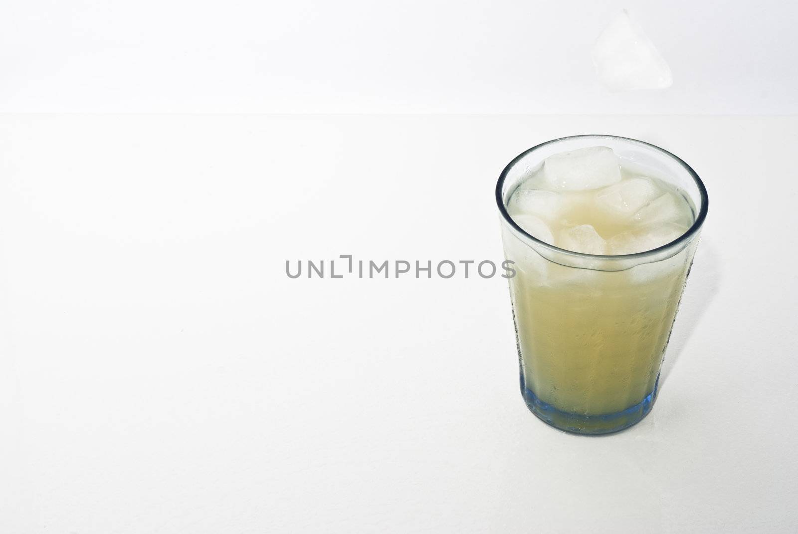 elegant cocktail glass with ice cube  isolated on white background