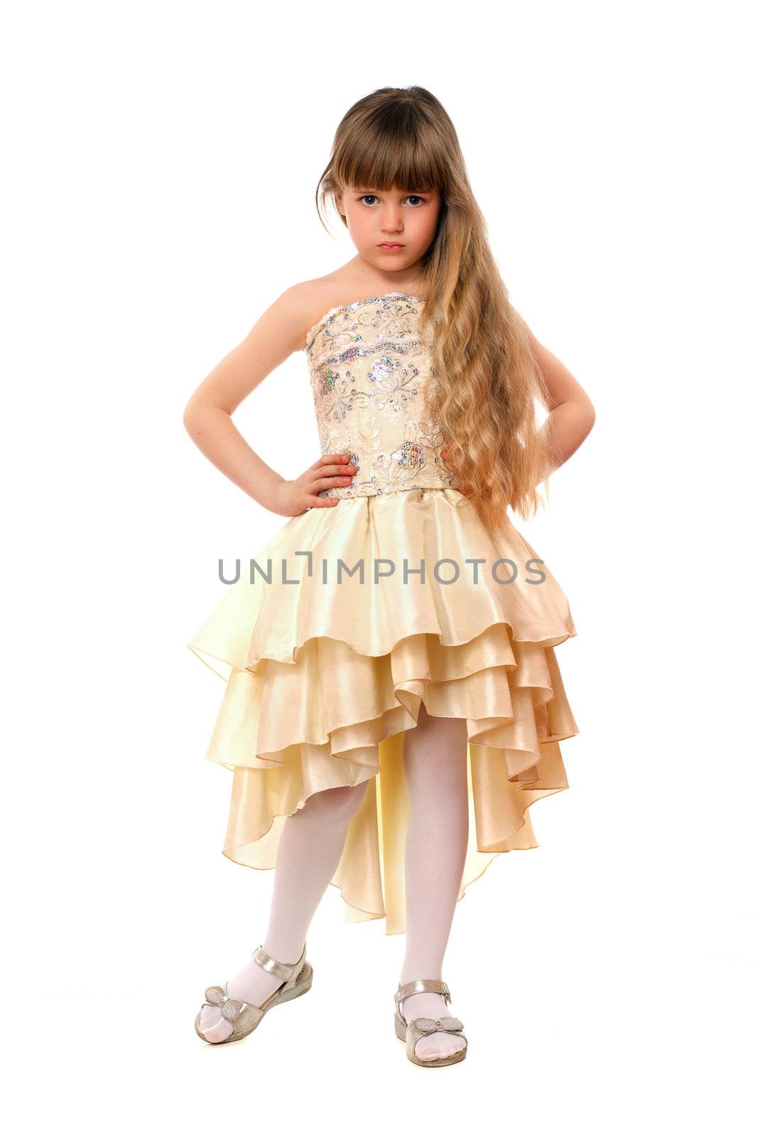Beautiful little girl in a beige dress. Isolated