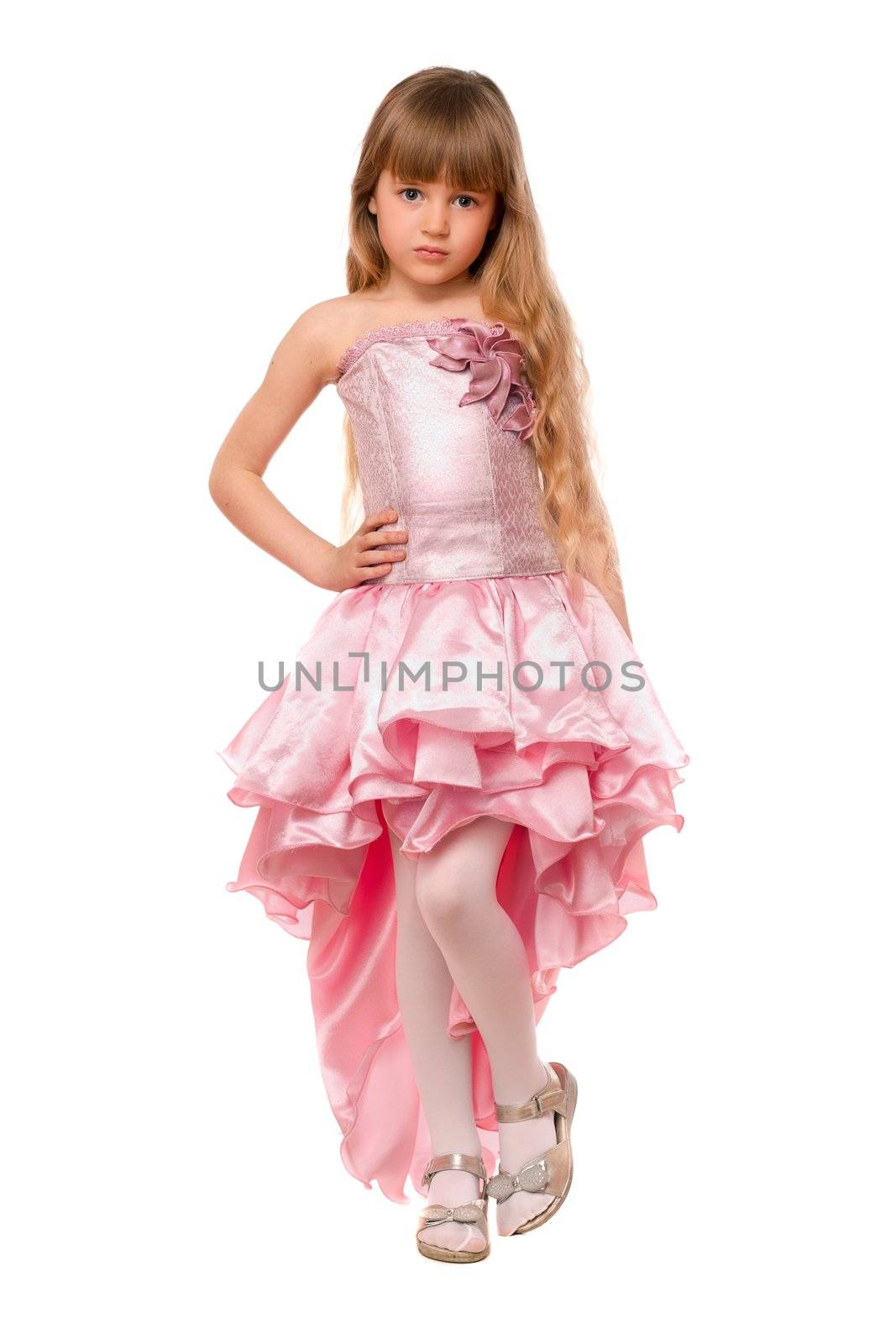 Pretty little girl in a chic pink dress. Isolated