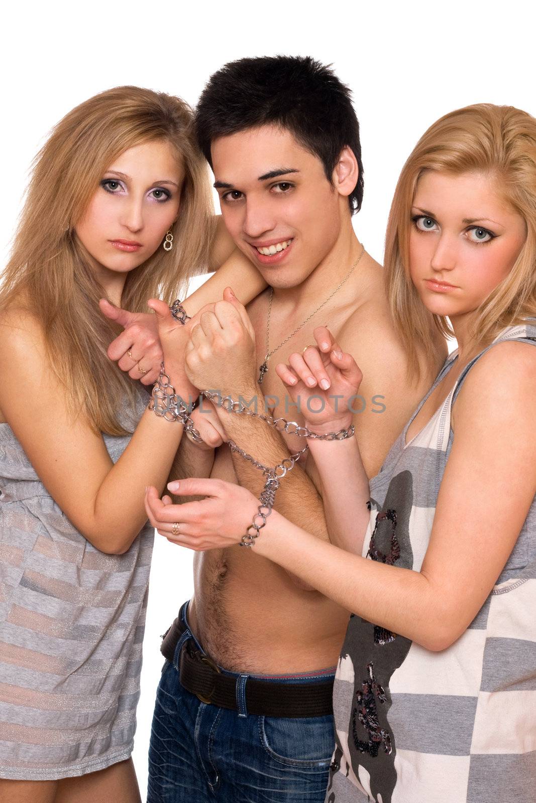 Playful young man and two sad blonde in chains