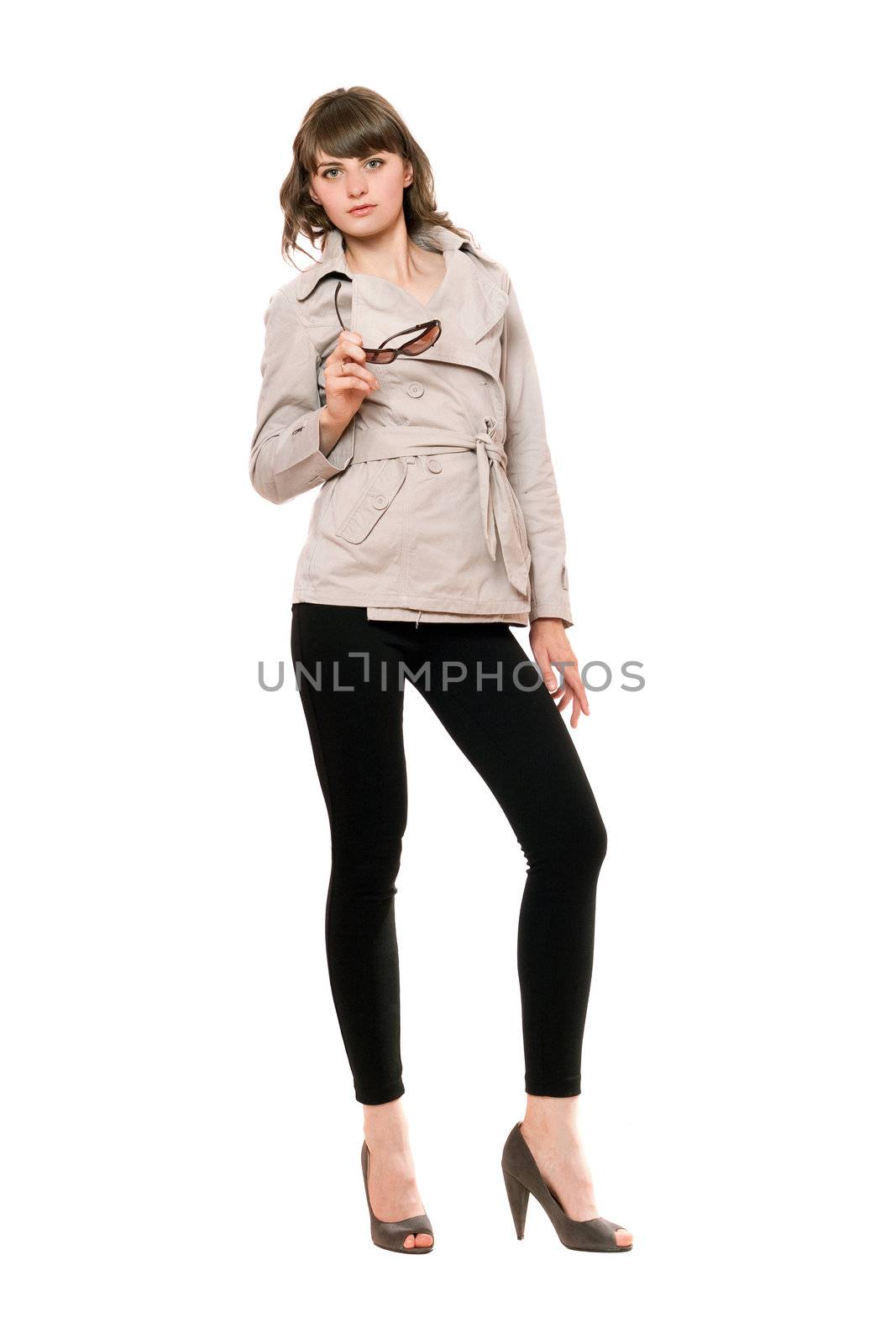 Attractive girl wearing a coat and black leggings. Isolated on white