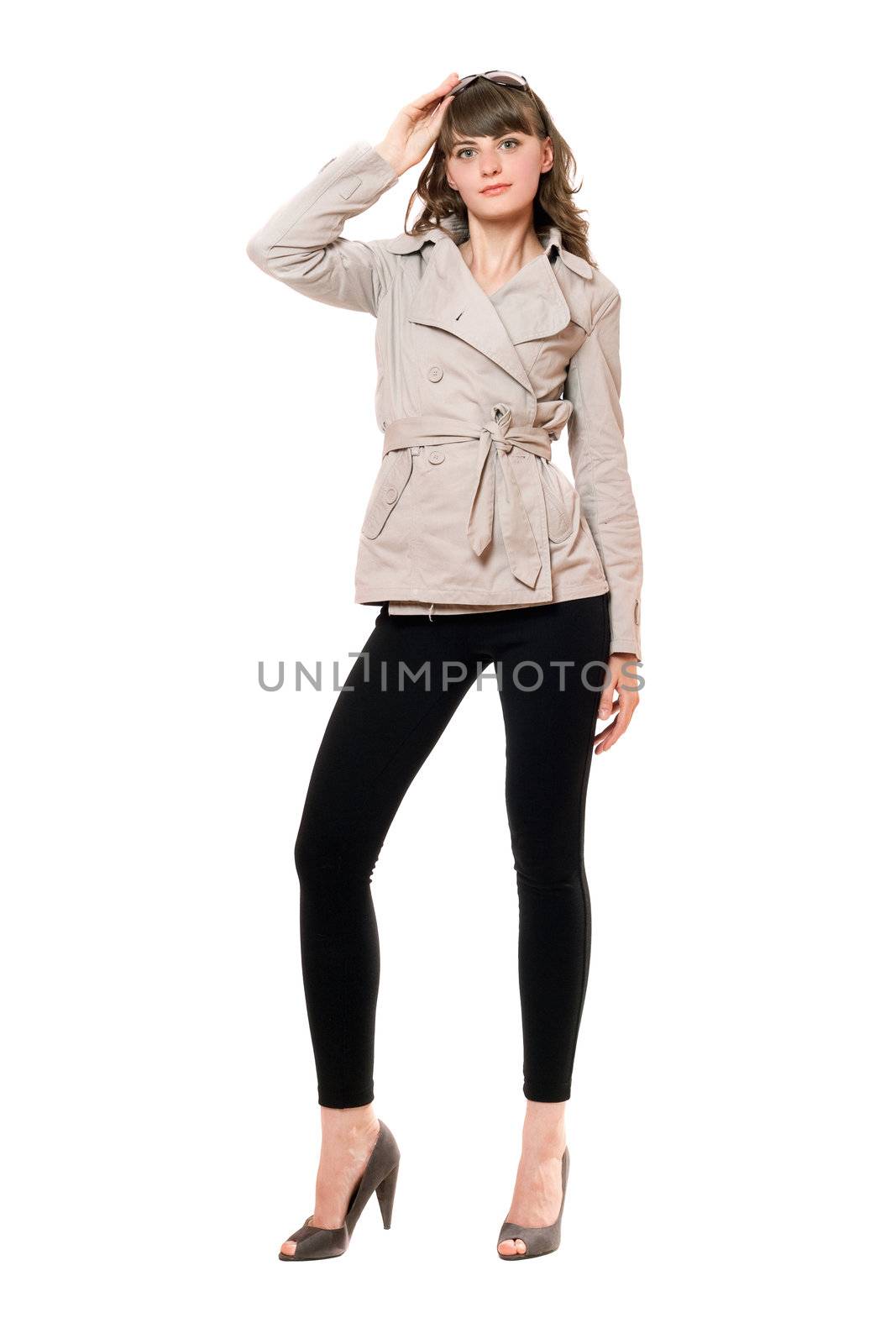 Lovely girl wearing a coat and black leggings. Isolated on white