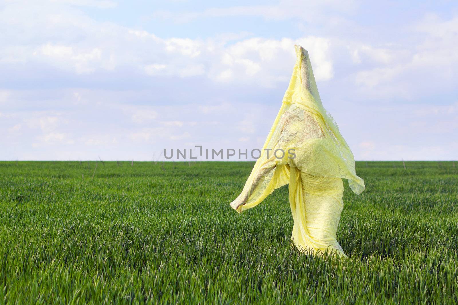 Young flexible woman wrapped in yellow cloth