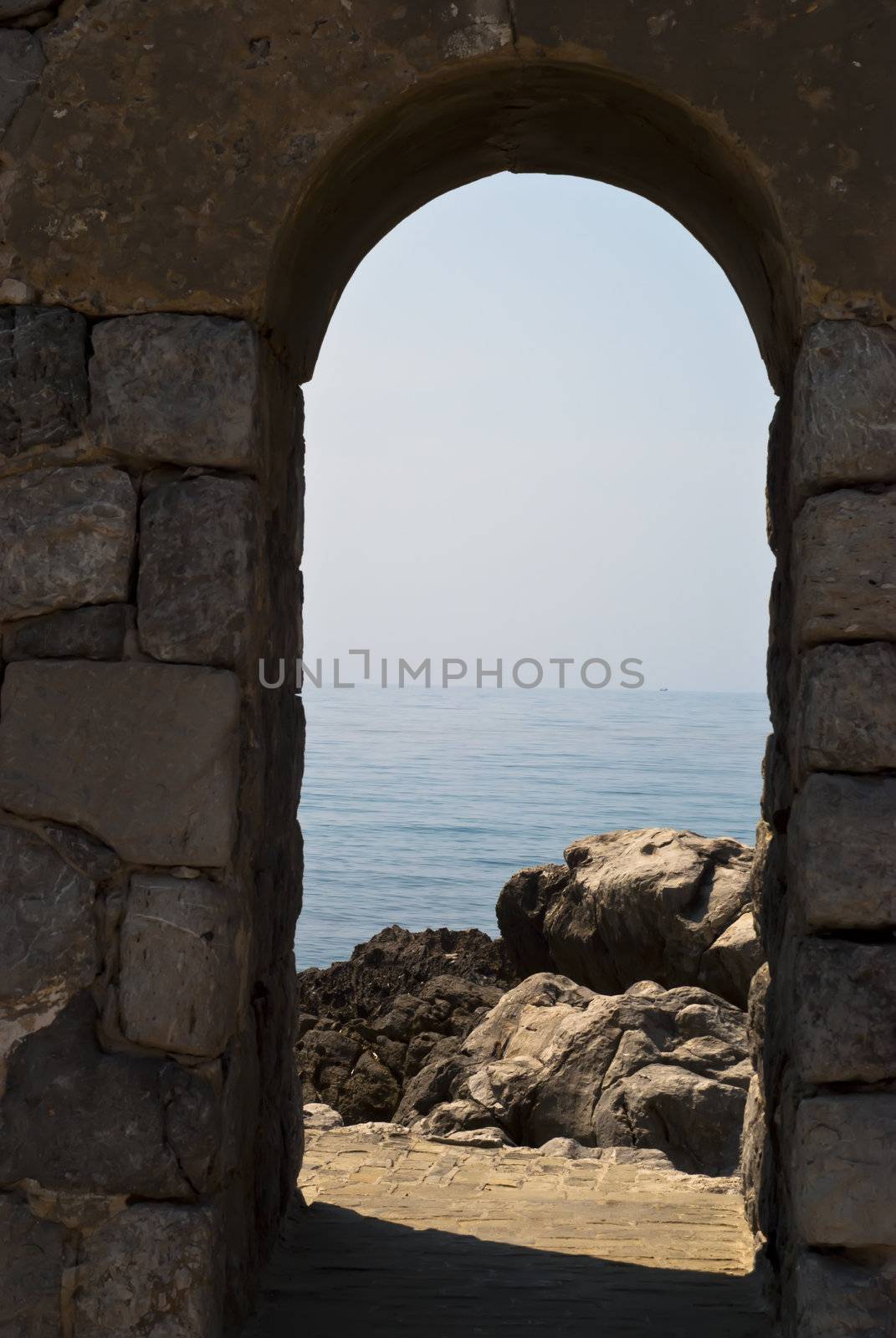 old arch with sea and rocks in Cefalu. Sicily