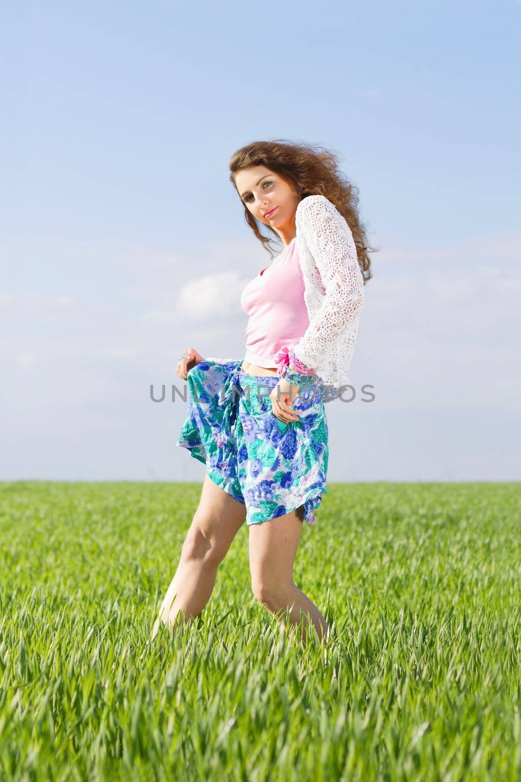 Pretty young woman in a green field