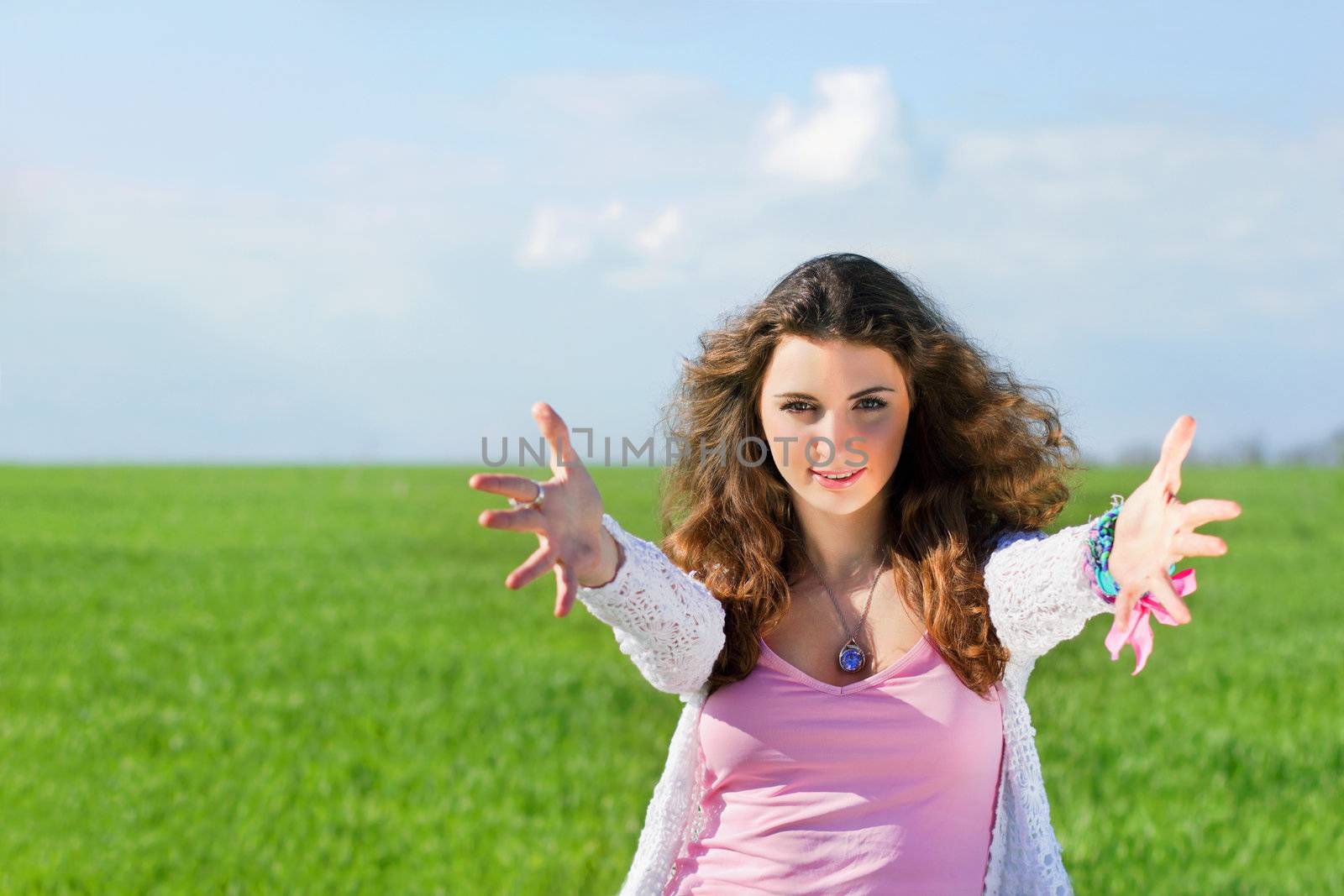 Portrait of smiling young woman in a green field