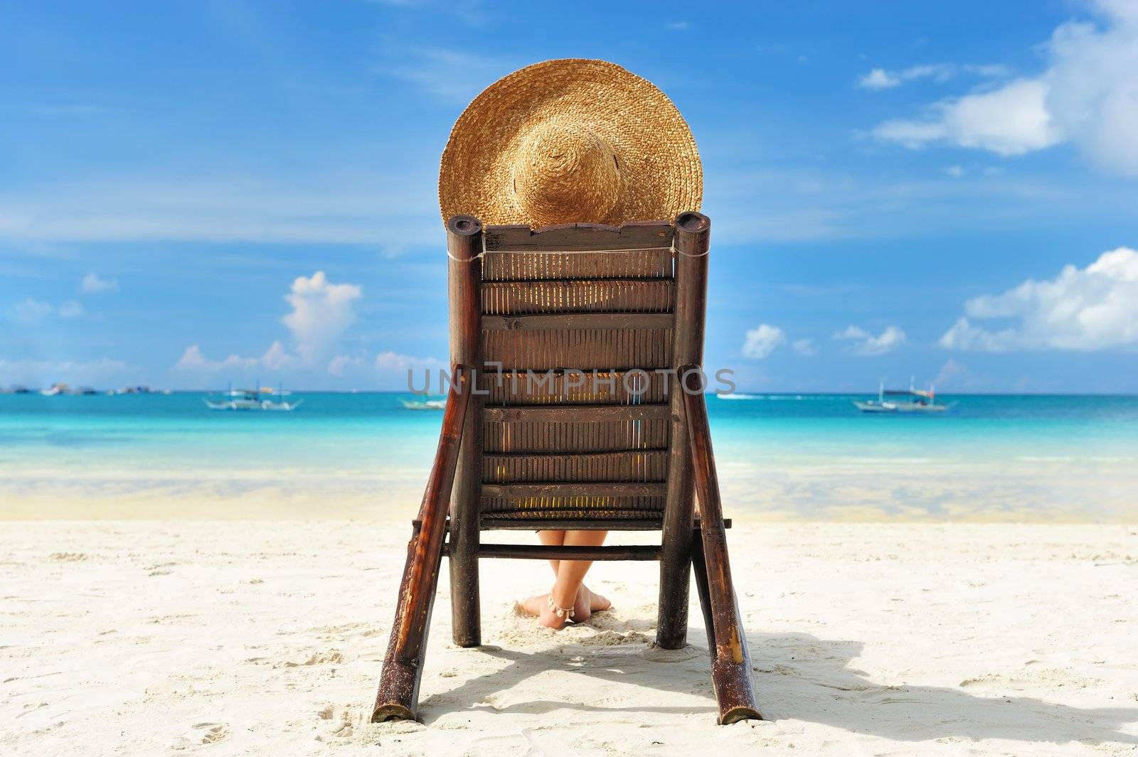 Girl on a tropical beach with hat