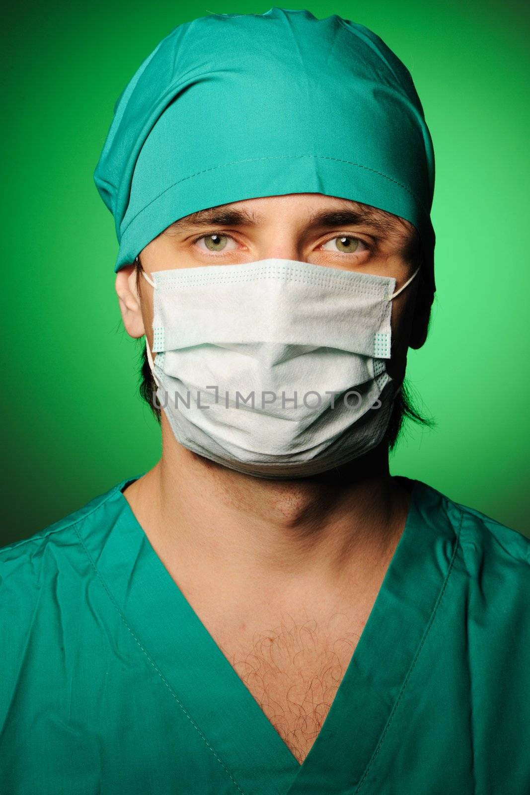 Surgeon in mask over green