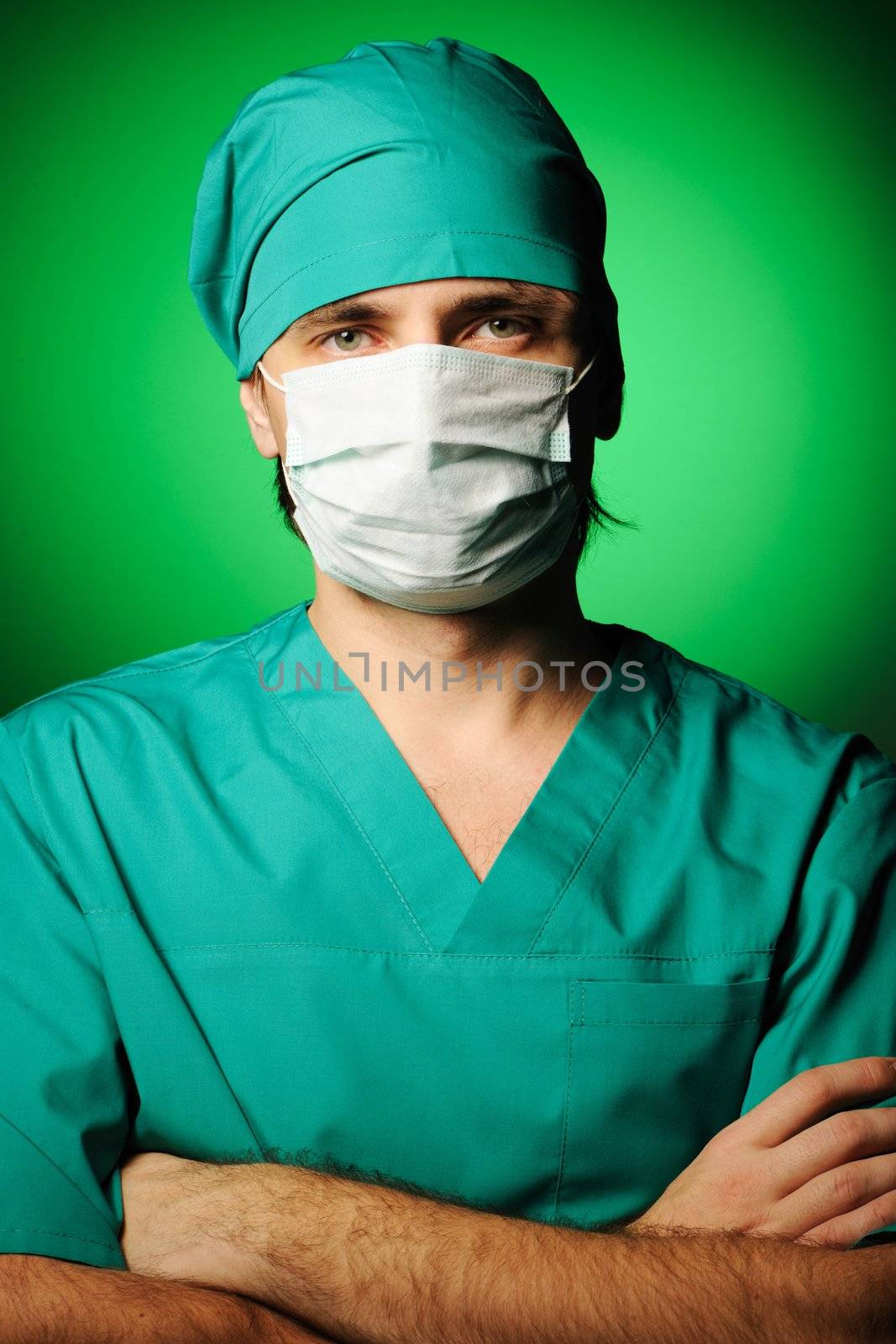 Surgeon in mask over green