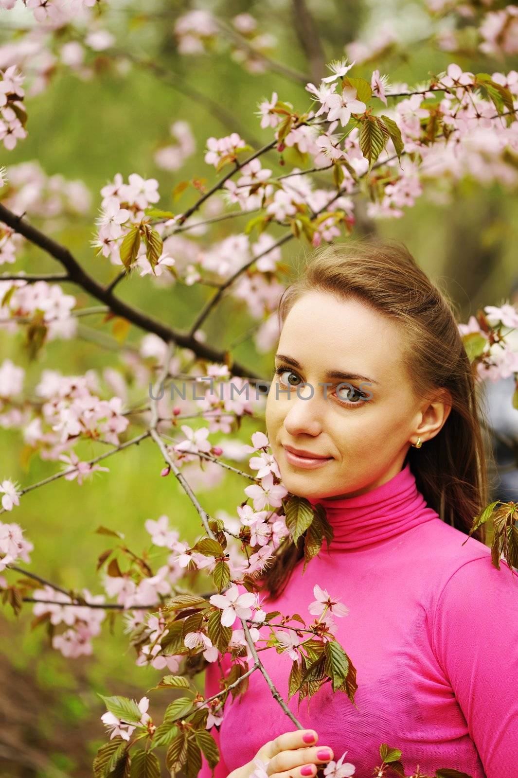 Woman in front of sakura blossoms by haveseen
