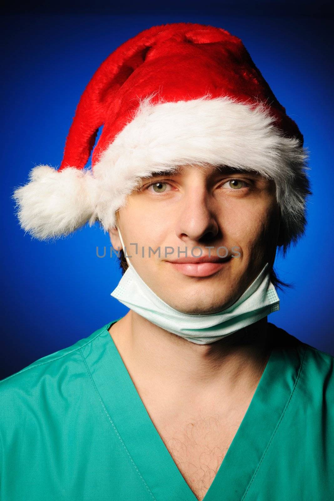 Surgeon with mask in Santa's hat