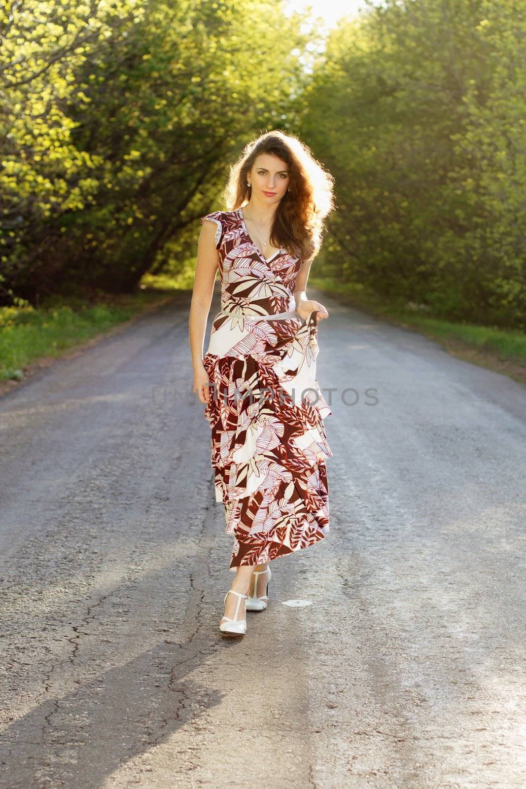 Attractive young woman walking on the road