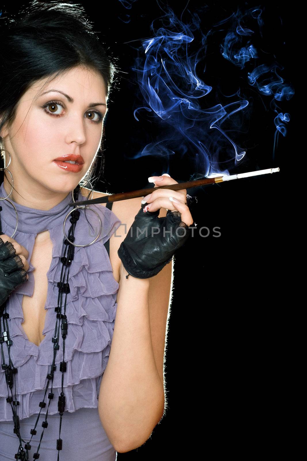Portrait of a beautiful brunette with cigarette holder