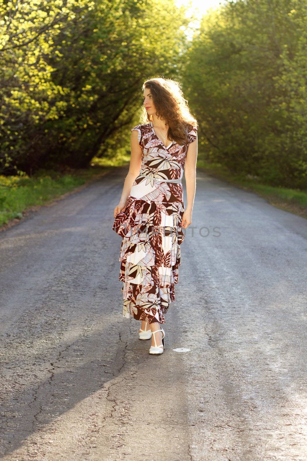 Attractive young woman standing on the road