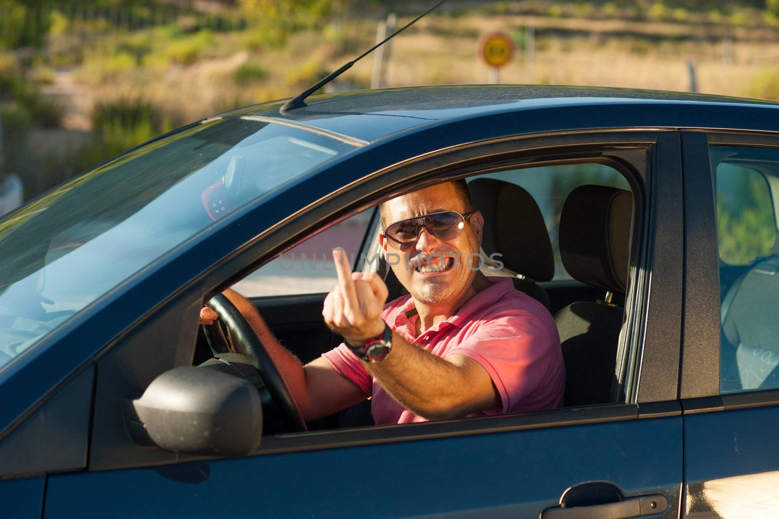 A very angry driver in his car.