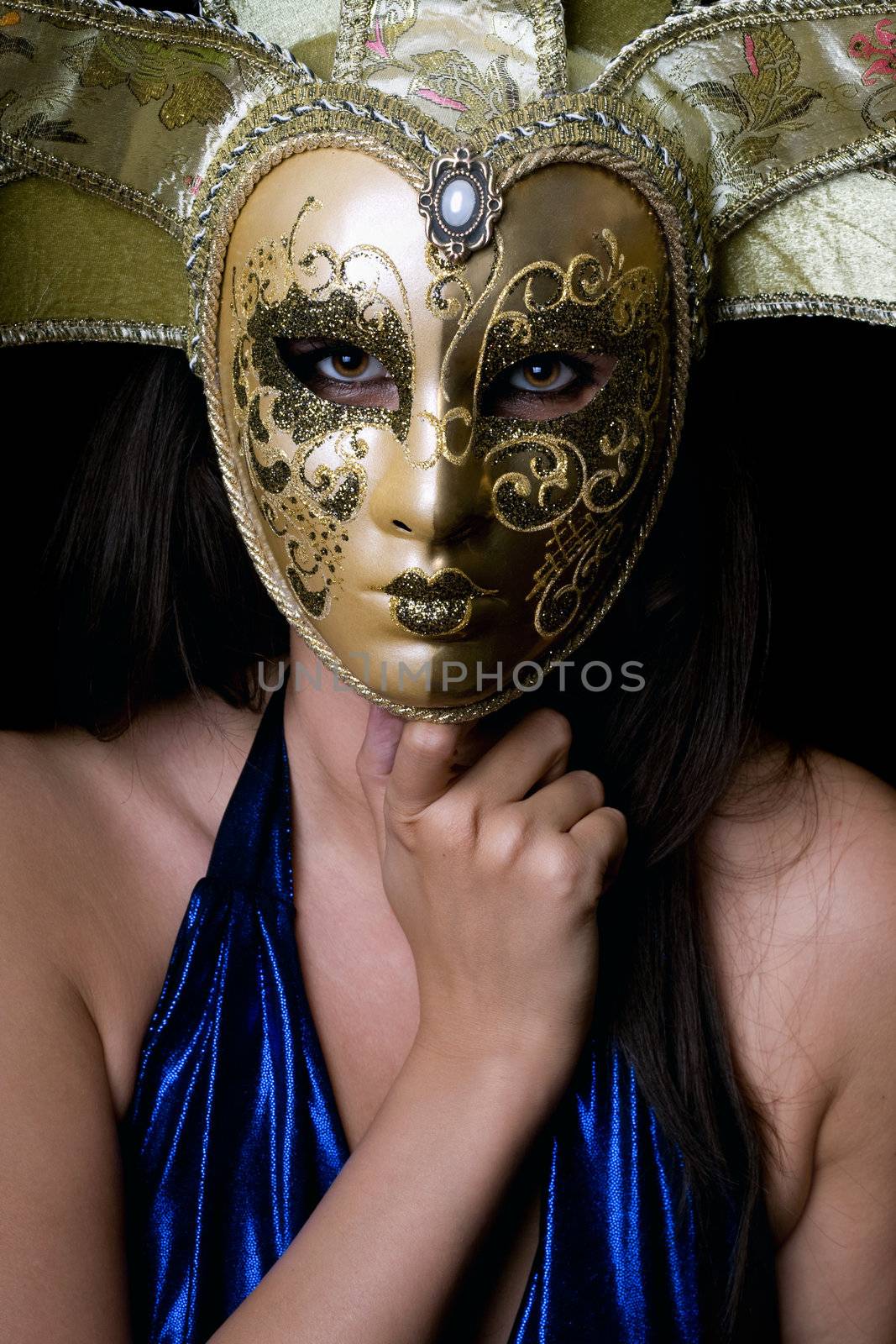 Portrait of young woman in a Venetian mask. Isolated