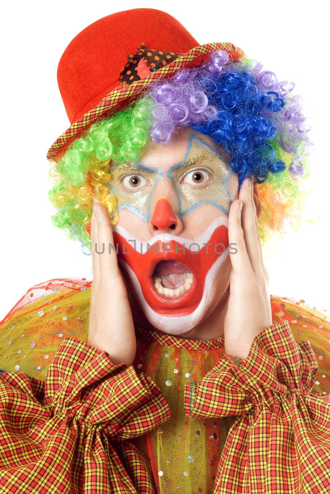 Close-up portrait of a terrified clown. Isolated on white