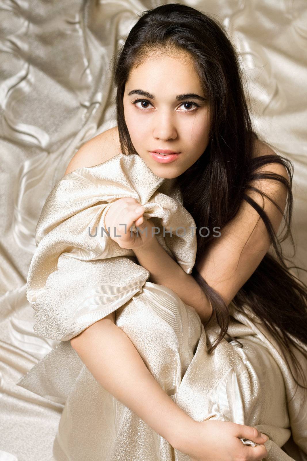 Portrait of a pretty girl sitting in bed