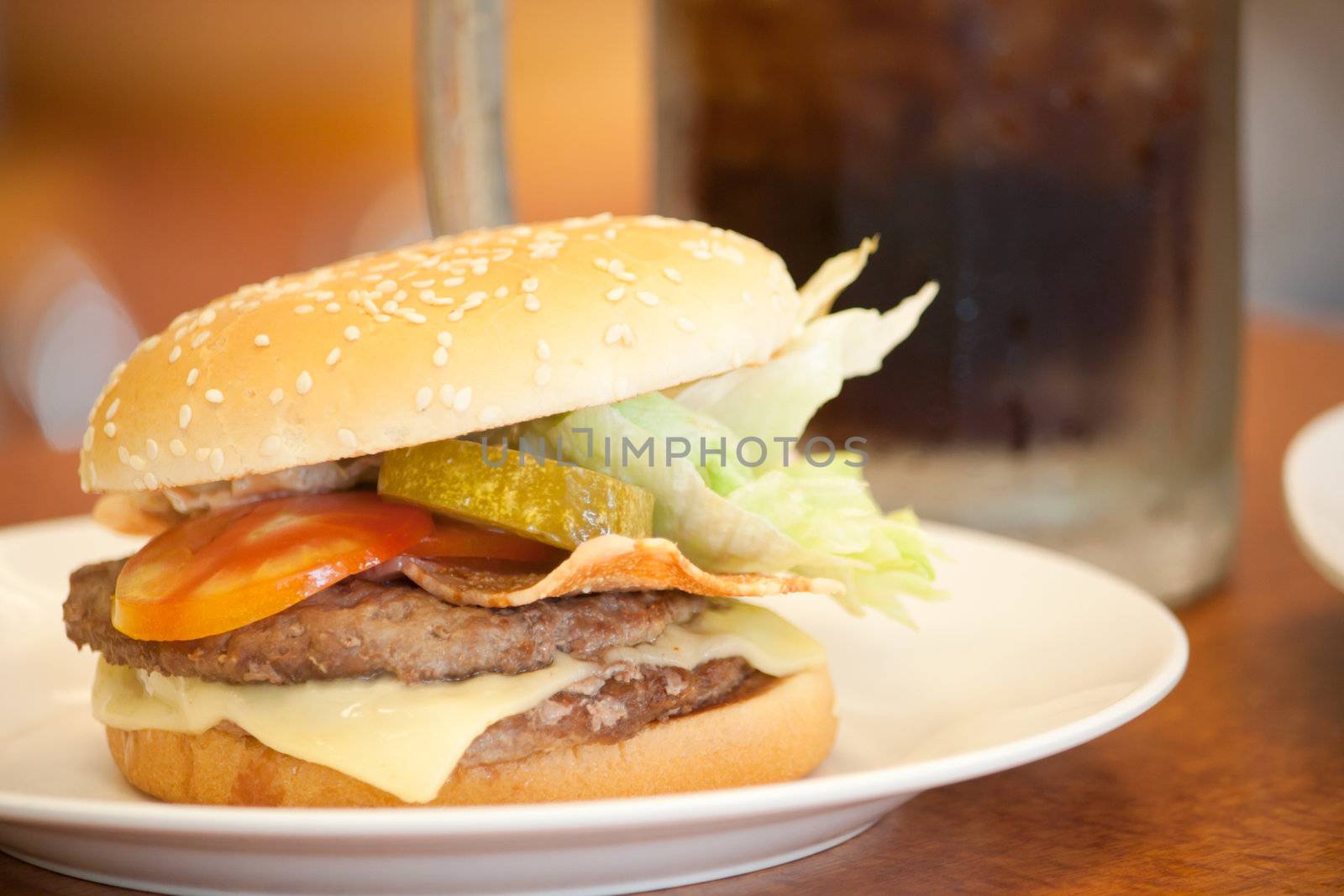 Cheeese burger in white plate at a shop, shallow depth of field