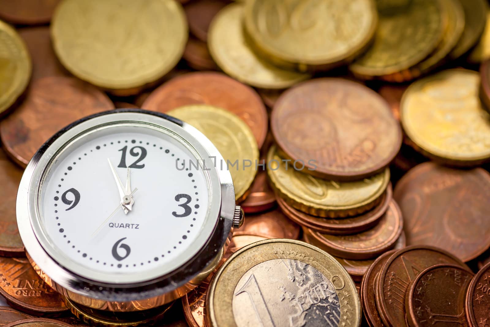 Euro coins and a clock showing 5 minutes until 12.