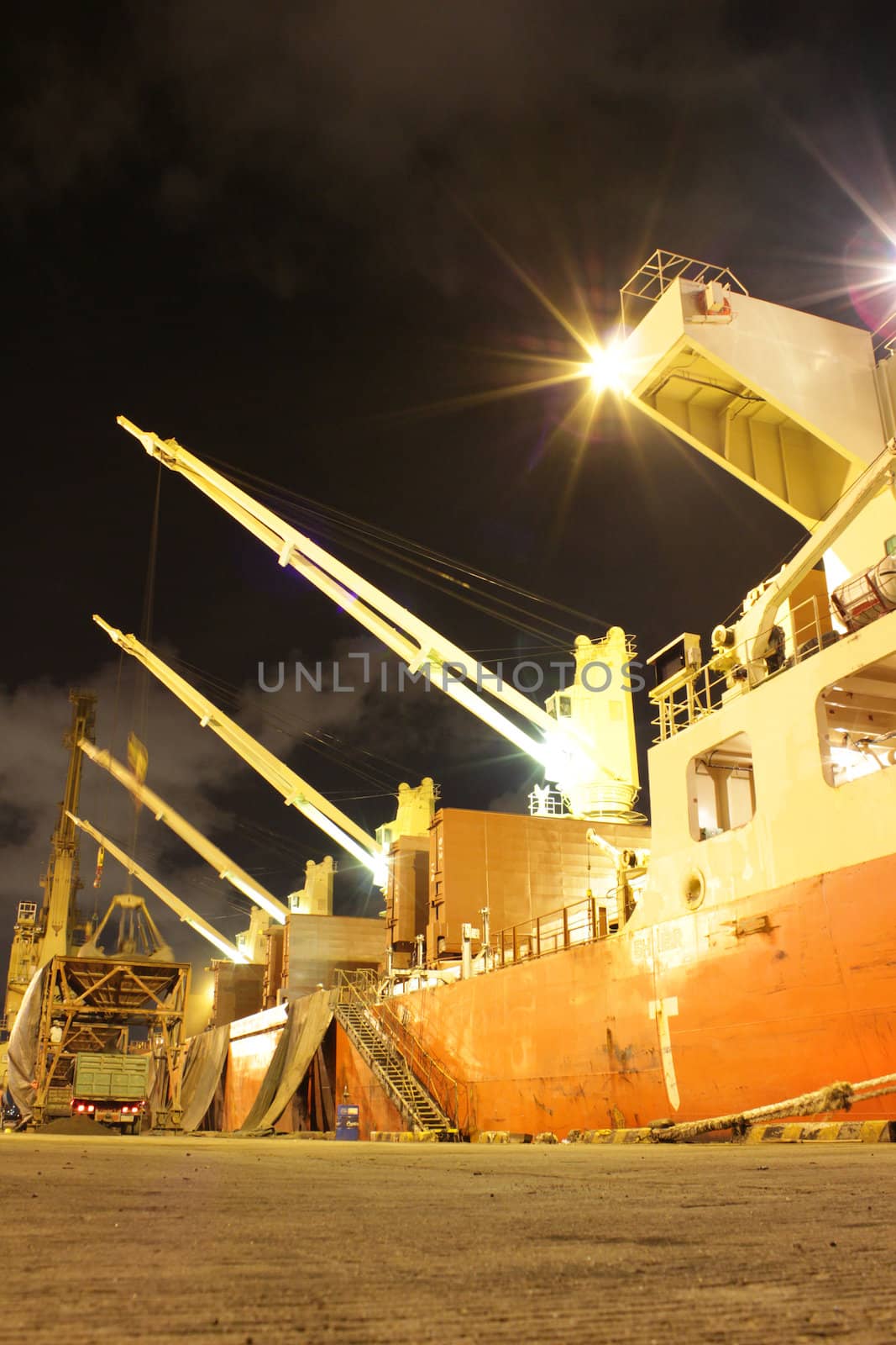 Cargo jetty on the night with green lighting 