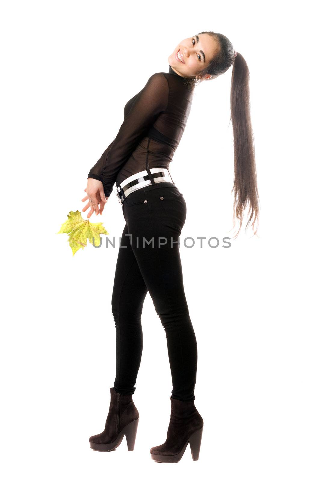 Beautiful young brunette in a black pants. Isolated