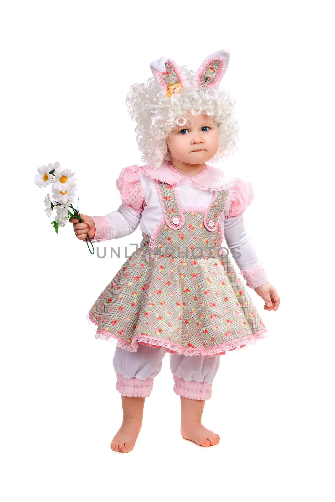 Little girl with flowers in hand wearing a dress