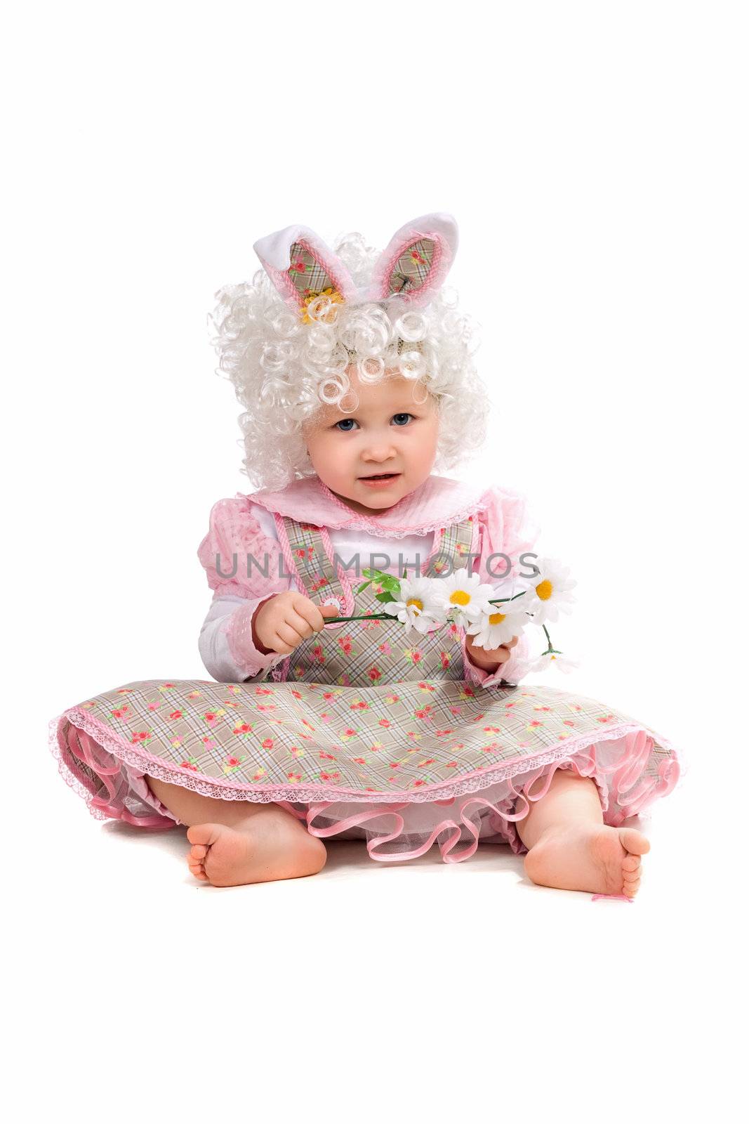 Little girl with flowers in hand wearing a dress. Isolated