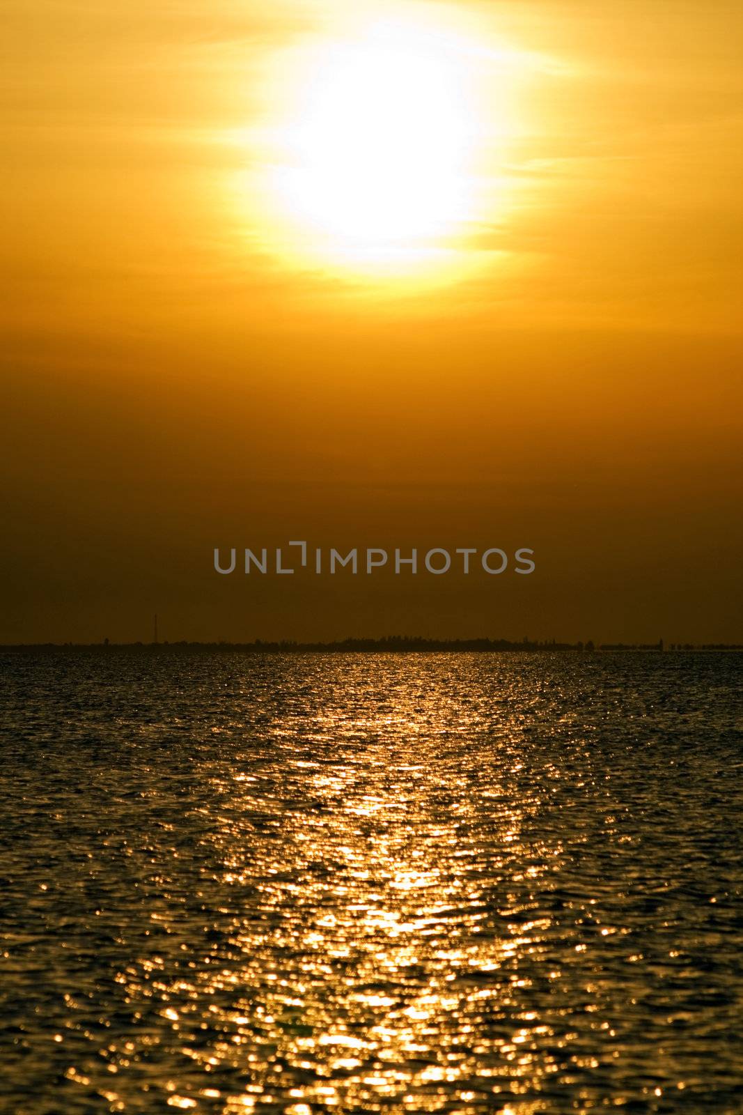 Calm sea bay at the orange sunset