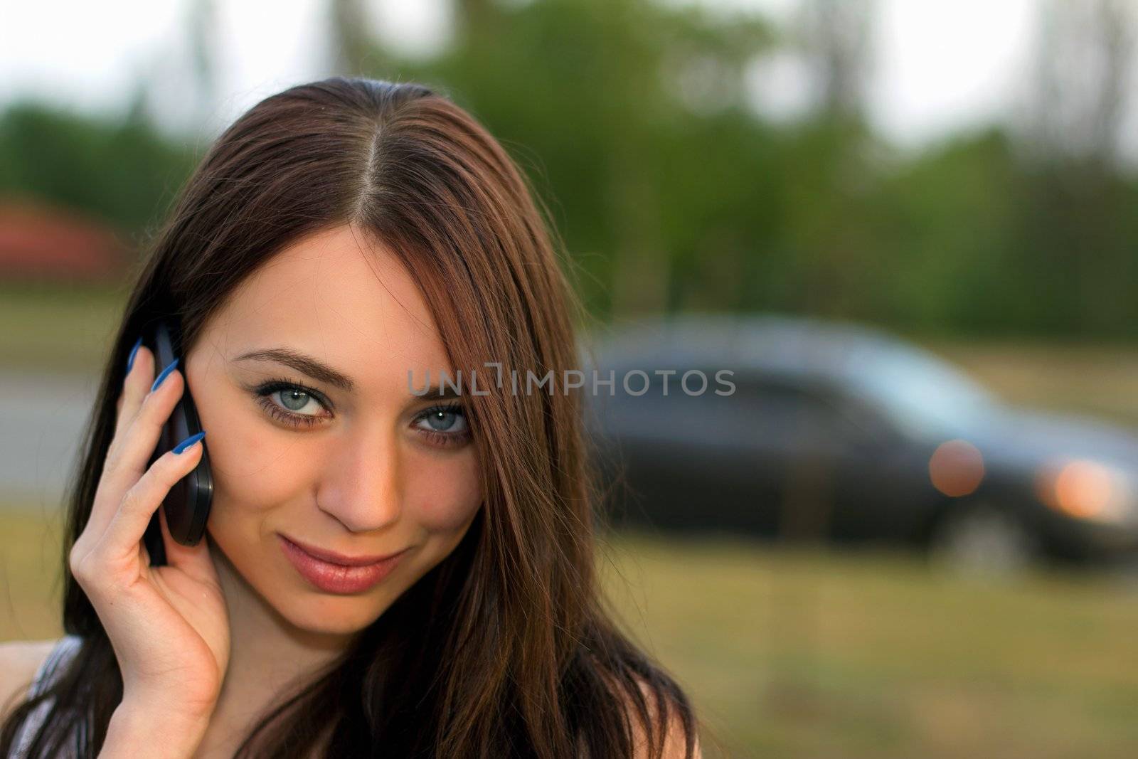 Smiling beautiful young woman calling by phone