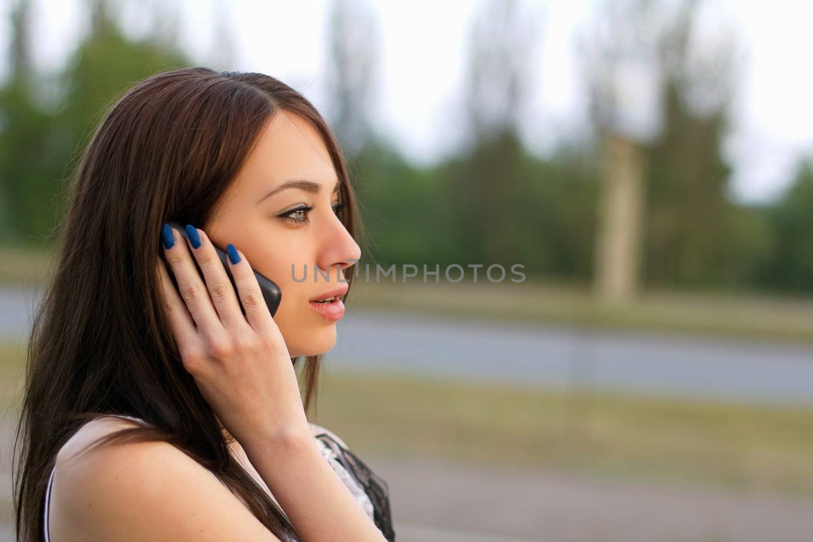 Beautiful young woman talking on the phone