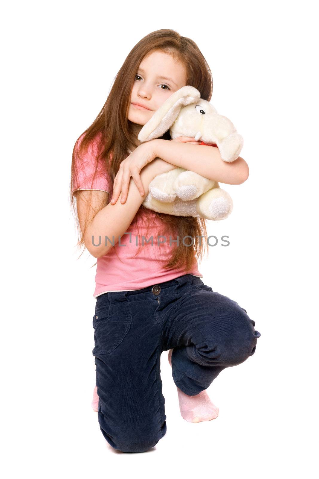 Happy little girl with a teddy elephant. Isolated
