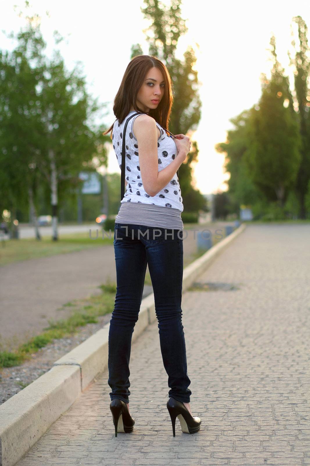 Perfect young woman standing on the sidewalk