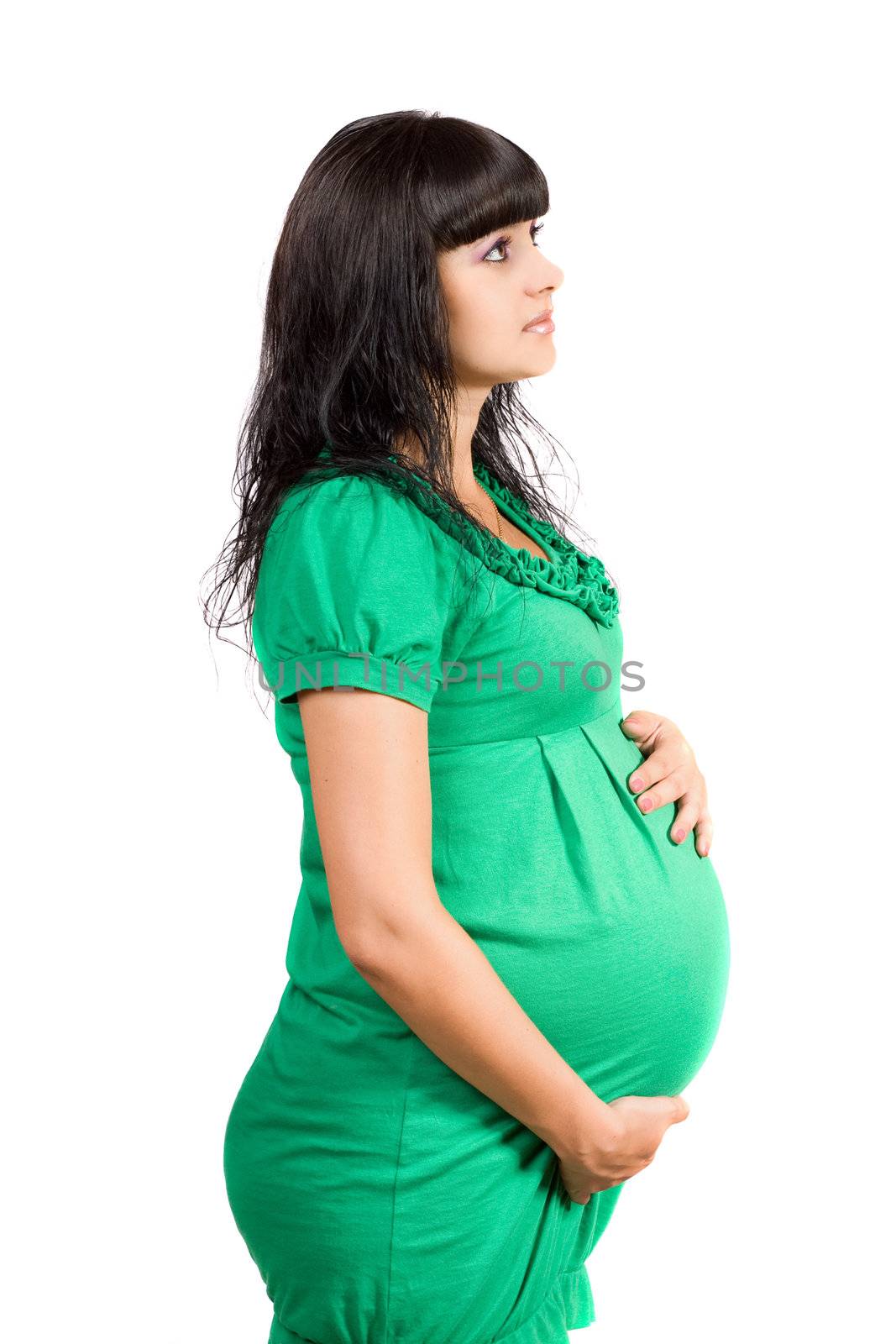 Portrait of a pregnant pretty girl in green dress