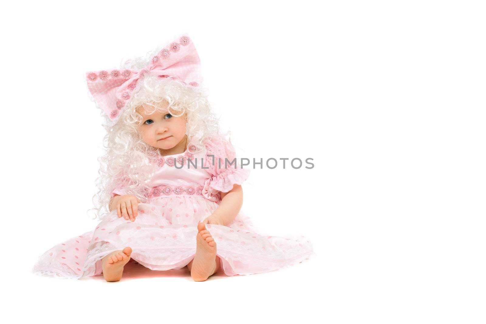Baby girl in a pink dress. Isolated on white