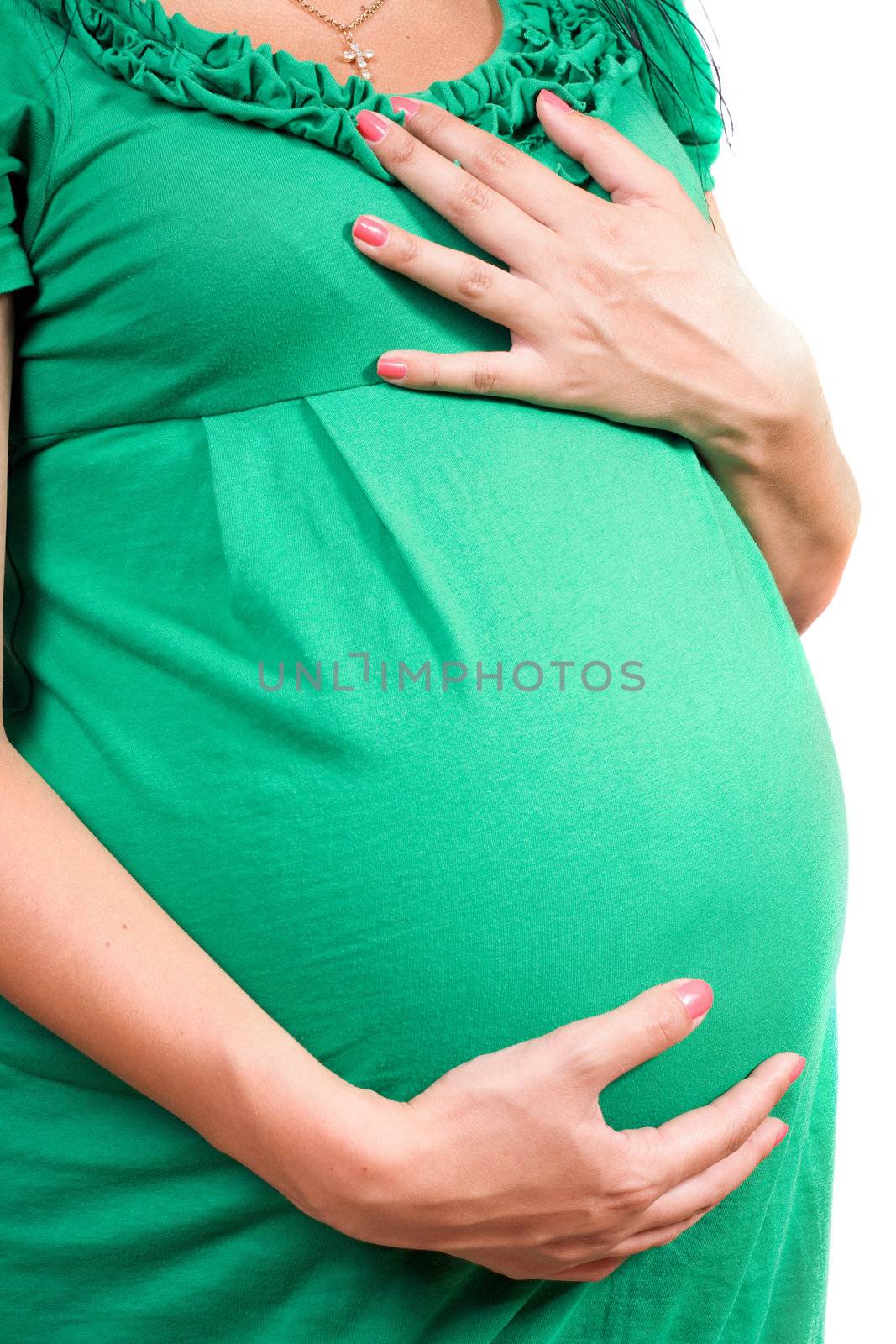Belly of a pregnant girl in green dress. Isolated on white