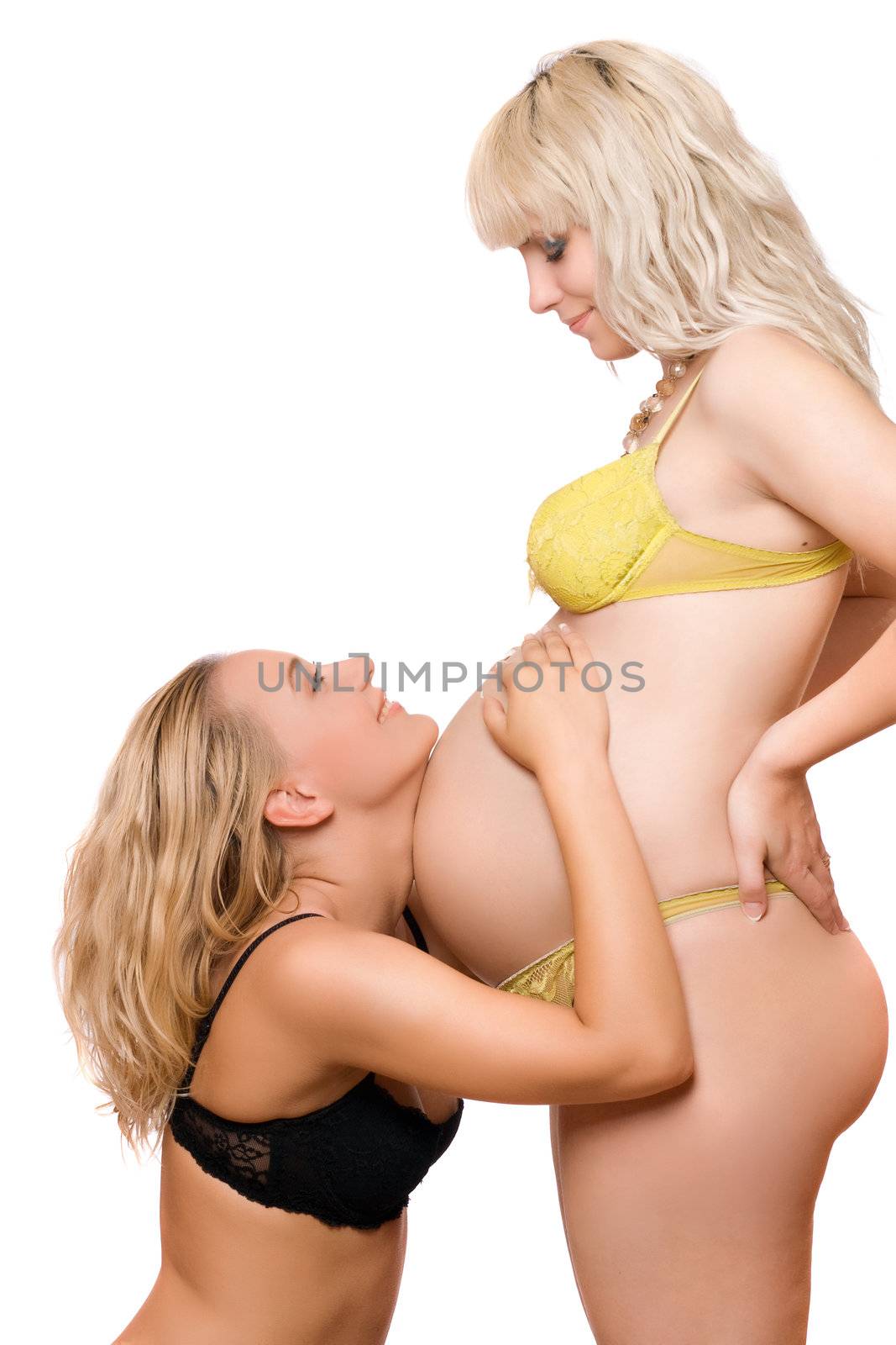 Pregnant woman with the joyful girlfriend. Isolated on white