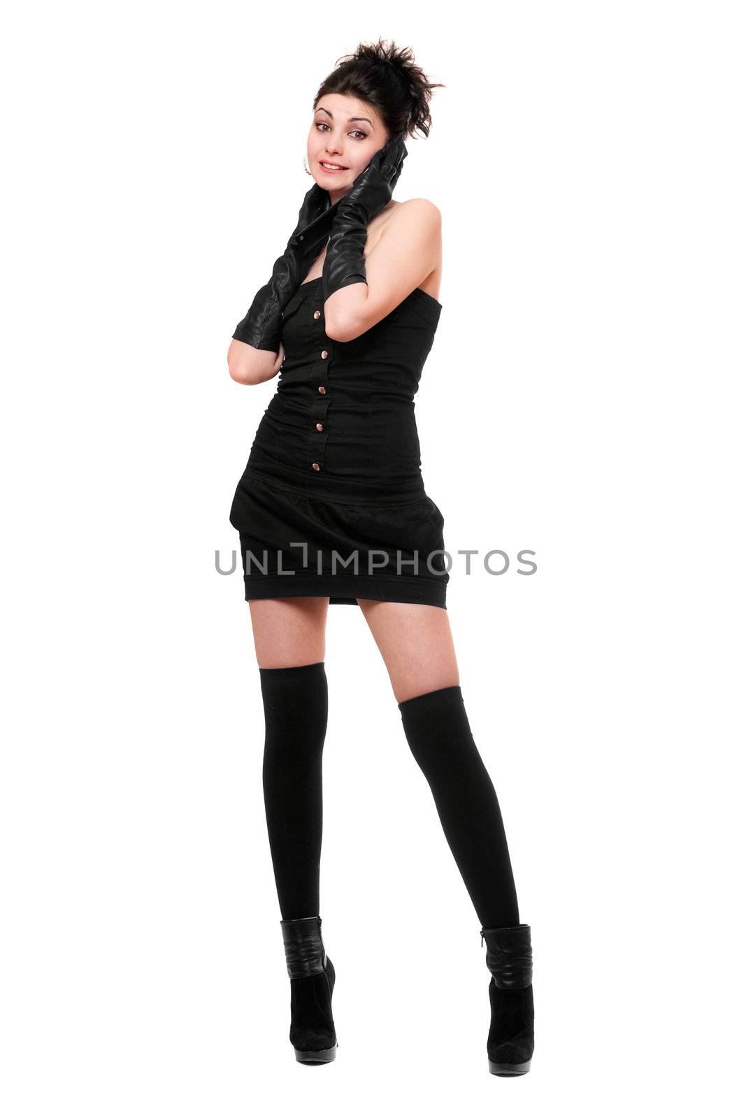 Happy young woman in a black dress talking on the phone