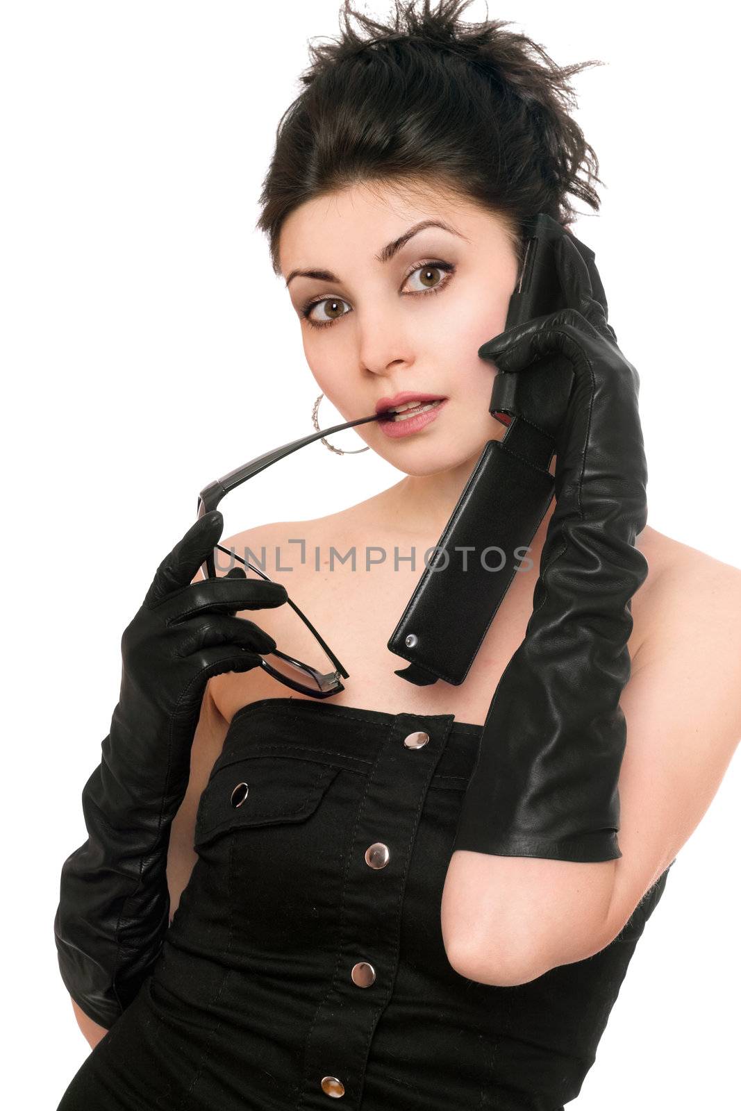 Portrait of surprised young woman talking on the phone. Isolated