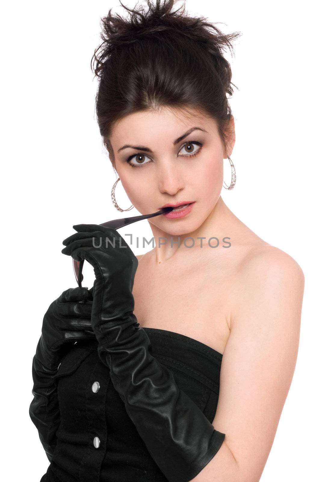 Portrait of attractive young brunette in a black dress. Isolated