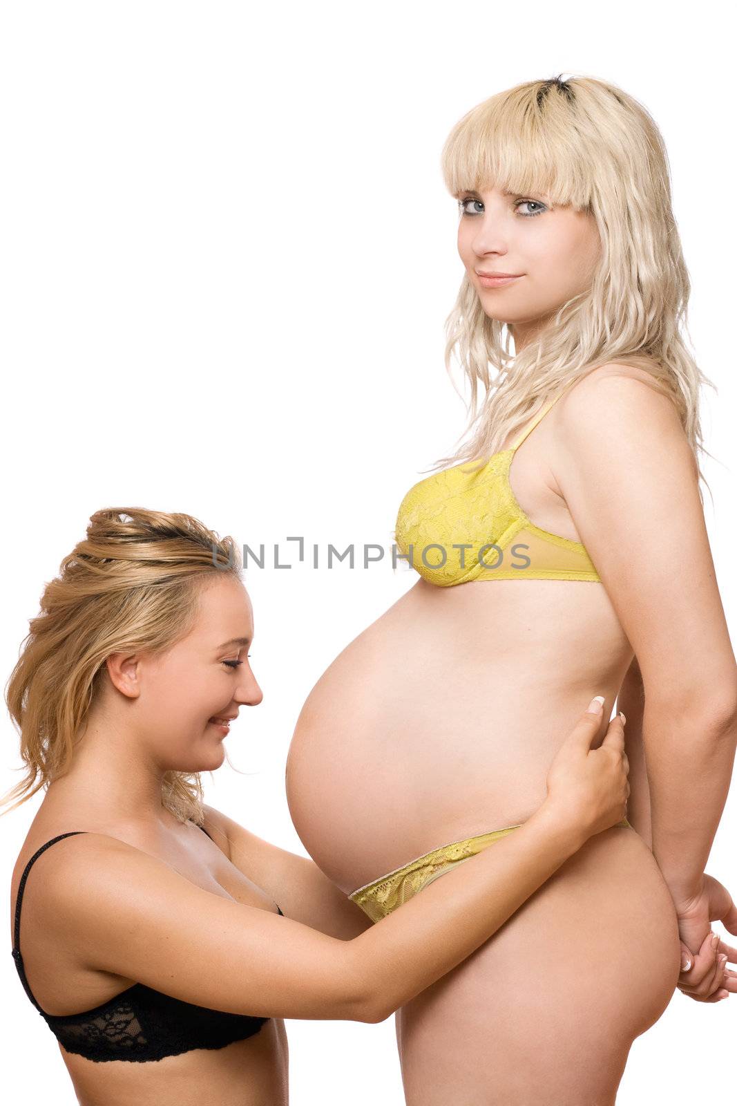 Smiling young woman and a pregnant girlfriend