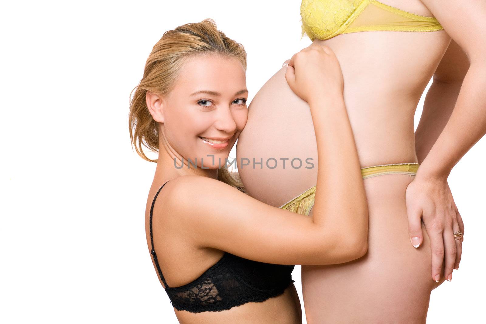 Cheerful girl and belly of pregnant girlfriend