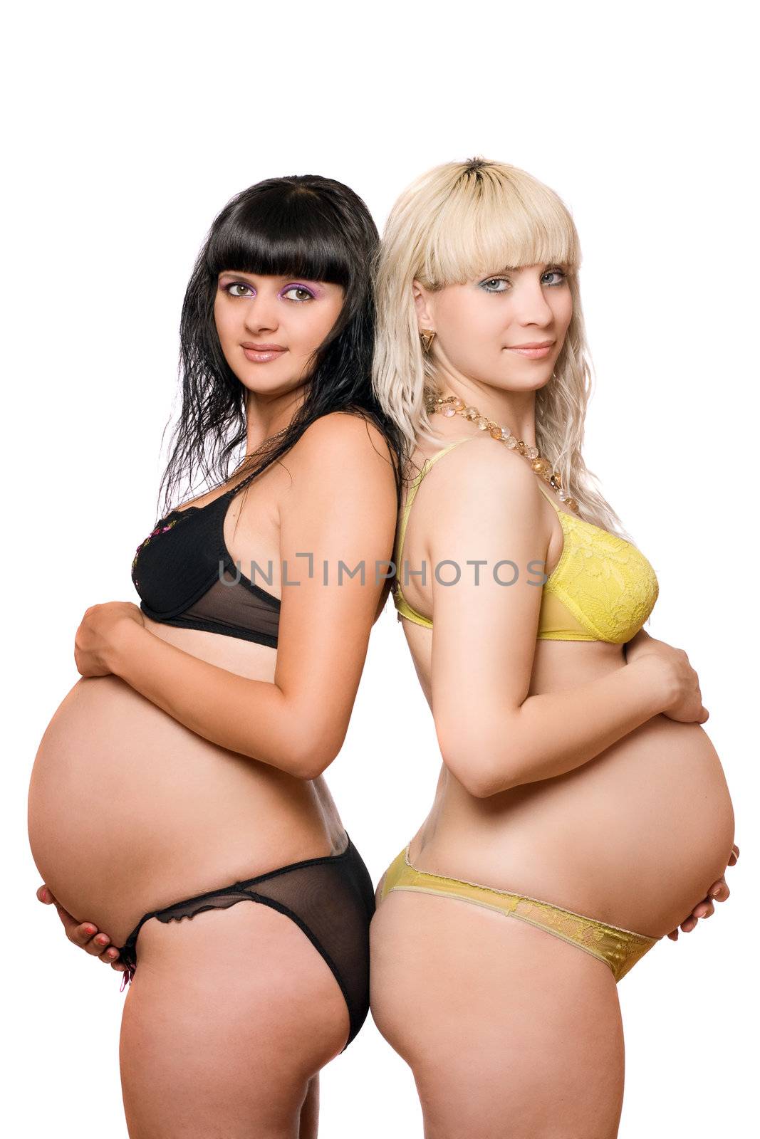 Pregnant blonde and brunette. Isolated on white background
