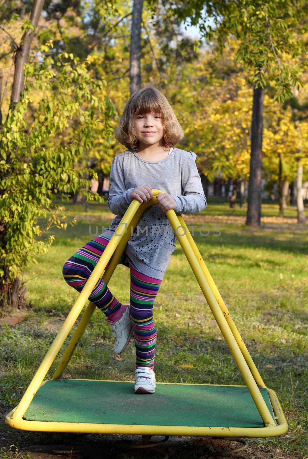 beautiful little girl on playground by goce