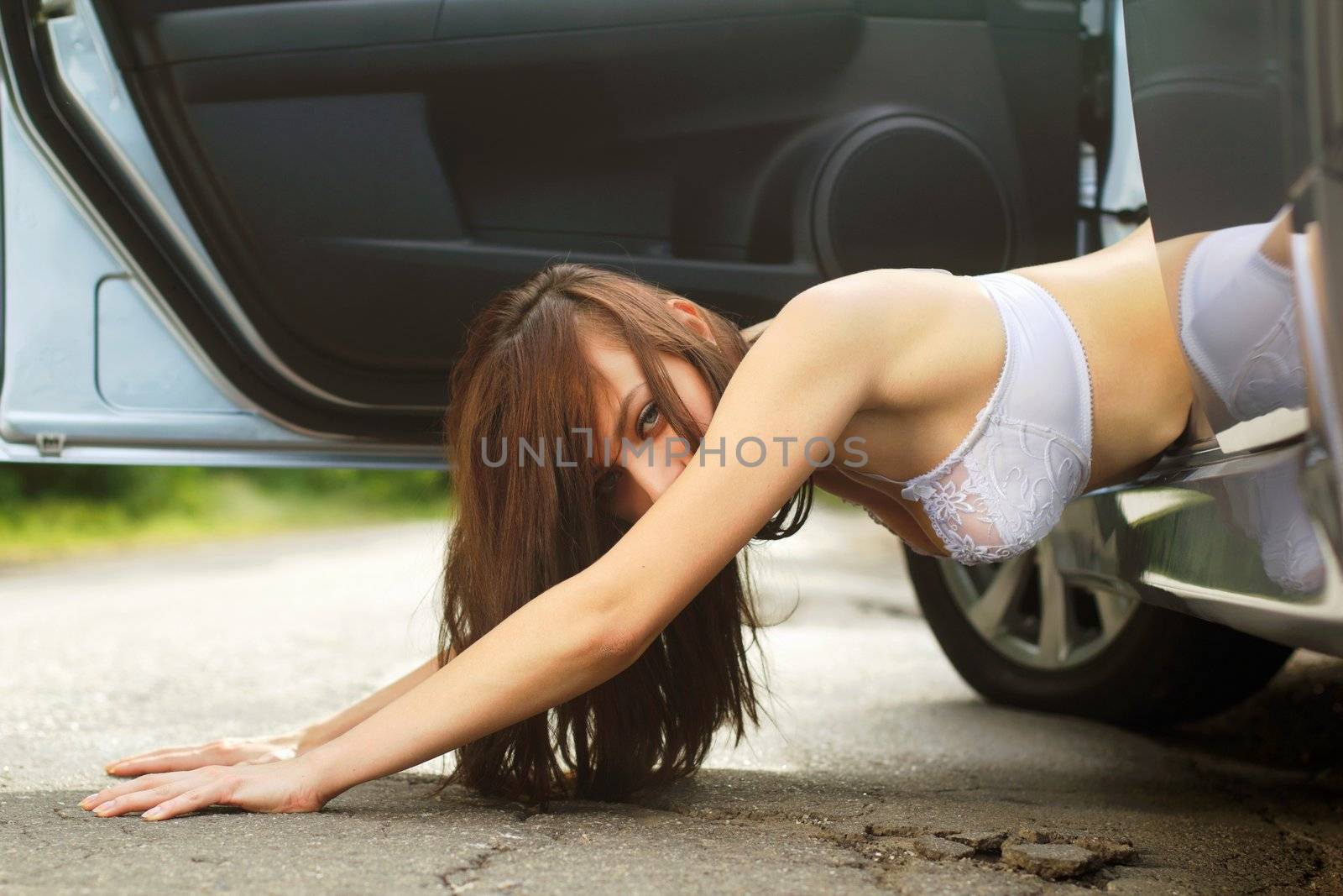Cute young woman lying on the road